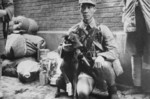 Chinese soldier with a wounded war dog, late 1930s
