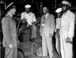 Lester Granger chatting with African-American US Navy S1/c Rofes Herring, S2/c Walter Calvert, and civilian Nollie H. Million, 20 Jun 1945; the officer was identified as Lt Roper