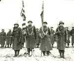 Japanese-American color guard of the US 442nd Regimental Combat Team standing at attention while citations are read following the fighting in Bruyeres, France, 12 Nov 1944