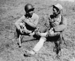 An US-trained Chinese soldier who had trained in India (left) speaking to a soldier of the Chinese Expeditionary Force who had marched from southern China, Muse, Burma, 1944-1945