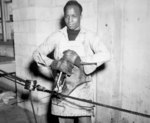 US Navy African-American Seaman 1st Class E. Perry splacing steel cable, 17 May 1945