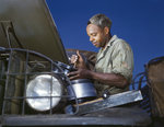 African-American mechanic in the US Army maintaining a truck, Fort Knox, Kentucky, United States, Jun 1942, photo 2 of 2