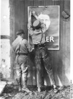 Two German Nazi Party SA men putting up an election poster featuring Adolf Hitler, Mecklenburg, Germany, summer 1932
