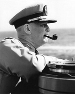 Admiral Burke smoking a pipe aboard a ship, circa 1955-1957
