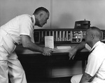 Rear Admiral William F. Rayborn and Admiral Arleigh A. Burke examing a cutaway model of submarine USS George Washington, Jul 1959