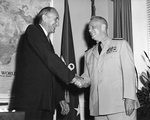 Secretary of the US Navy William B. Franke congratulating Admiral Arleigh A. Burke on his third term as Chief of Naval Operations, Aug 1959