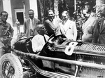 Benito Mussolini in an Alfa Romeo race car, Villa Torlonia, Rome, Italy, 19 Aug 1932; left to right: Amedeo Bignami, unknown, Benito Mussolini, Prospero Gianferrari, Tazio Nuvolari, Achille Starace, Mario Umberto Borzacchini