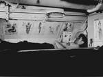 American sailor reading in his bunk aboard USS Capelin, Aug 1943