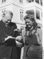 A Norwegian female worker receiving Minister President Vidkun Quisling