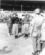 US Army Lieutenant General Lucian Truscott of 5th Army saluting the guidon of 442nd RCT, Livorno, Italy, Sep 1945
