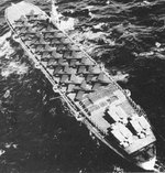 Acavus underway with aircraft on her deck, circa 1940s