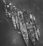 Destroyer Harusame, a minesweeper, destroyer Akizuki, a destroyer, repair ship Akashi, seaplane tender Sanyo Maru, another destroyer, and a patrol boat at Truk, Caroline Islands, Feb 1943