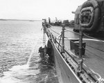 Chicago of Guadalcanal the day after Battle of Savo Island, with crewmen cutting away torpedo-damaged plating to enable the ship to get underway, 10 Aug 1942