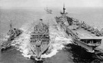 Carrier USS Antietam and destroyer USS Shelton being refueled by USS Tolovana off Korea, 1951-1952; seen in US Navy Naval Aviation News Nov 1952; note USS Essex in background