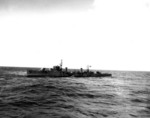 Japanese destroyer Hatsuzakura off Tokyo Bay with a whaleboat from USS Nicholas alongside to transfer Japanese translators and harbor pilots to Nicholas, 27 Aug 1945. Photo 1 of 2.