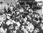 Survivors of USS Helena being transferred from cruiser USS Honolulu to shore stations on Espiritu Santo, New Hebrides, 17 Jul 1943.