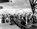 US Marines aboard USS Honolulu firing a salute during funeral services for Fireman 1st-class Irvin L. Edwards, a crew member of the sunken USS Helena who died of his wounds, 7 Jul 1943.