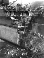Battleship Washington in drydock at Pearl Harbor Navy Yard to repair collision damage sustained from battleship Indiana in the previous month, US Territory of Hawaii, Mar 1944
