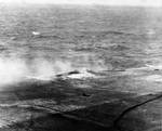 Damage to Lexington after bomb hit near the port forward 5-inch gun gallery, Battle of Coral Sea, 8 May 1942, photo 1 of 4