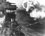 Minneapolis bombarding Butaritari Island, Makin Atoll, Gilbert Islands with her 5-in secondary guns, 20 Nov 1943; note rings of smoke