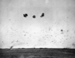 HMS Rodney (left), HMS Manchester (right), and other ships of the Operation Pedestal convoy under air attack while sailing for Malta, 11 Aug 1942