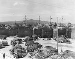 US Army CCKW 2 1/2-ton 6x6 cargo trucks bringing supplies to US Navy LSTs, Naples, Italy in preparation for the invasion of southern France, Aug 1944