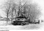 German Tiger I heavy tank with damaged track on a street, Russia, winter of 1943-1944; note Kübelwagen vehicle in background