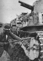 Japanese tanker clearing mud from the tracks of a Type 89 I-Go medium tank, China, late 1937 to early 1938