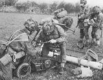 Welbike motorcycle being assembled in the field during an exercise in the United Kingdom, 22 Apr 1944