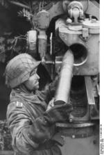 German soldier loading a shell into an 8.8 cm FlaK gun, France, 1944
