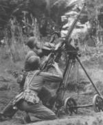 Chinese communist soldiers operating a DShK M1938 heavy machine gun as an anti-aircraft weapon, China, circa 1950s