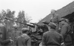 Major Alfons Kotowski (standing on gun), Adolf Pilch (right of photograph, with mustache), Lech Zabierek (next to Pilch, back facing camera), and others of Polish resistance Kampinos Regiment with a captured German 2 cm FlaK 38 gun during the Warsaw Uprising, Poland, Sep 1944