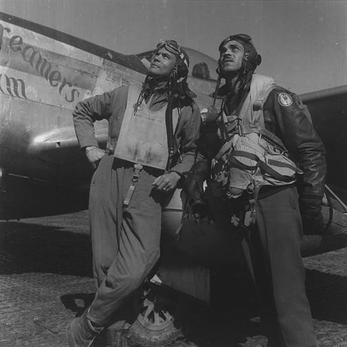 Colonel Benjamin Davis, Jr. and Captain Edward Gleed standing in front of fellow African-American pilot Lieutenant White's P-51D Mustang 'Creamer's Dream', Europe, circa 1944