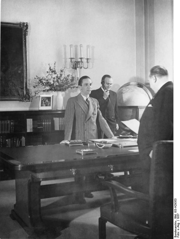 Josef Goebbels in a meeting with Government Secretary Walter Funk at the Propaganda Ministry, Berlin, Germany, 1937; Goebbels' personal secretary Karl Hanke in background