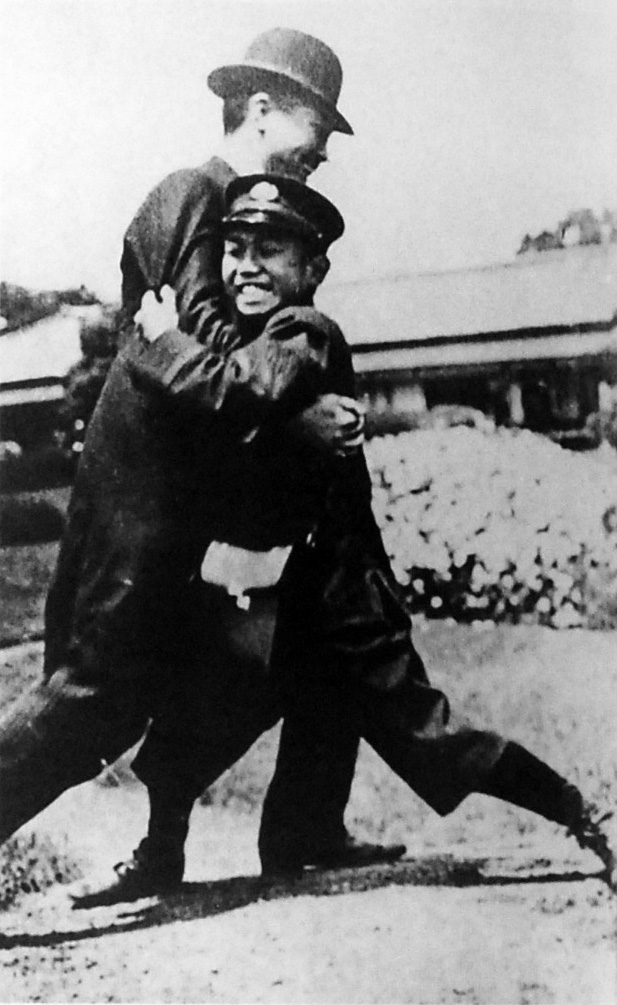 Young Prince Hirohito of Japan wrestling with a servant, Japan, 1913