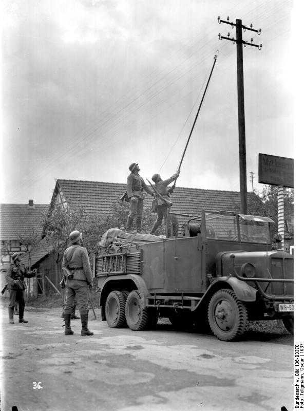 Troops of German 29th Division laying communication wire during field maneuvers, Bad Sachsa, Germany, 1937; note Büssing-NAG G31 truck