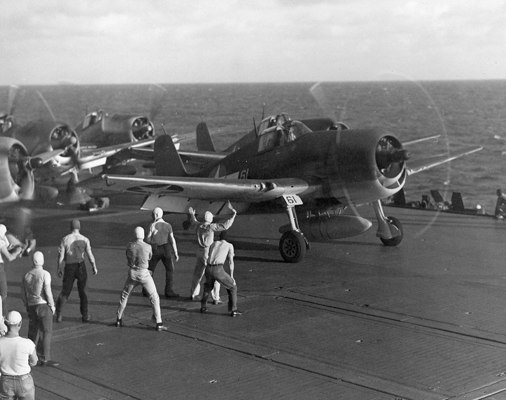 F6F Hellcat fighters going through launch procedures aboard the carrier Saratoga, off Gilbert Islands, early 1943.