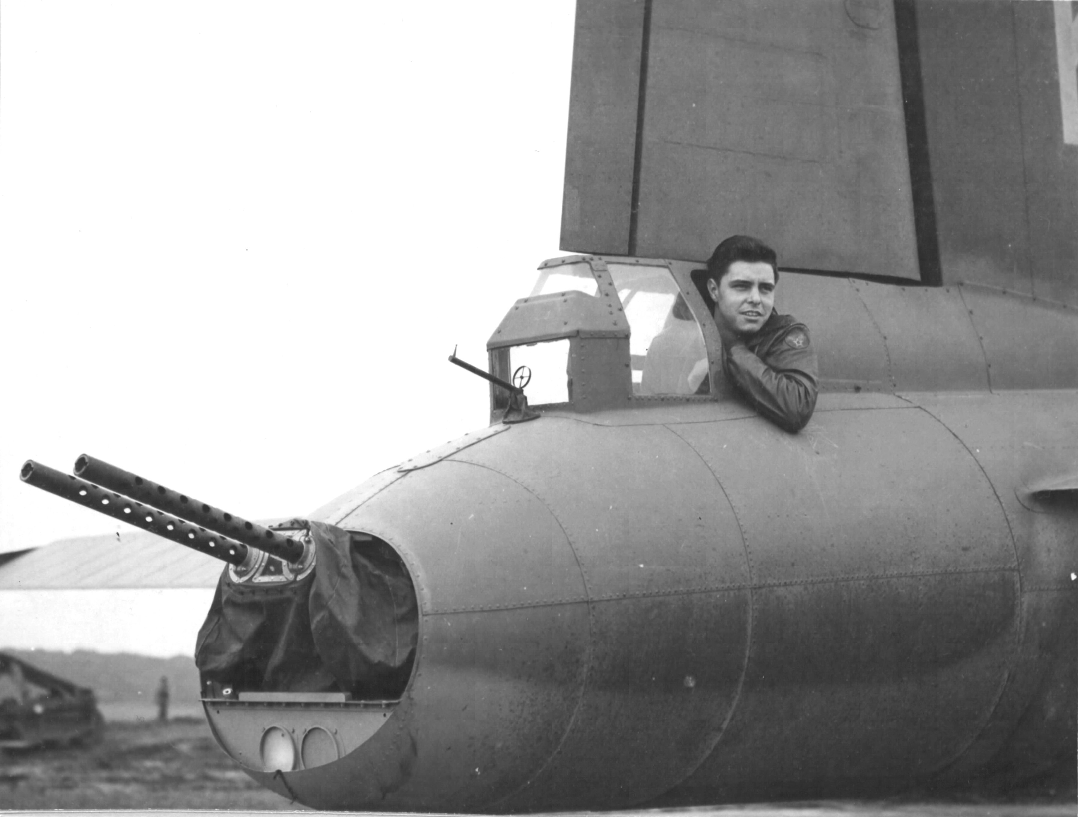 SSgt James F Jones, B-17 Fortress tail gunner with the 560th Bomb Squadron, 388th Bomb Group shows the tight fit of the position, RAF Knettishall, Suffolk, England, UK, Sep 1943