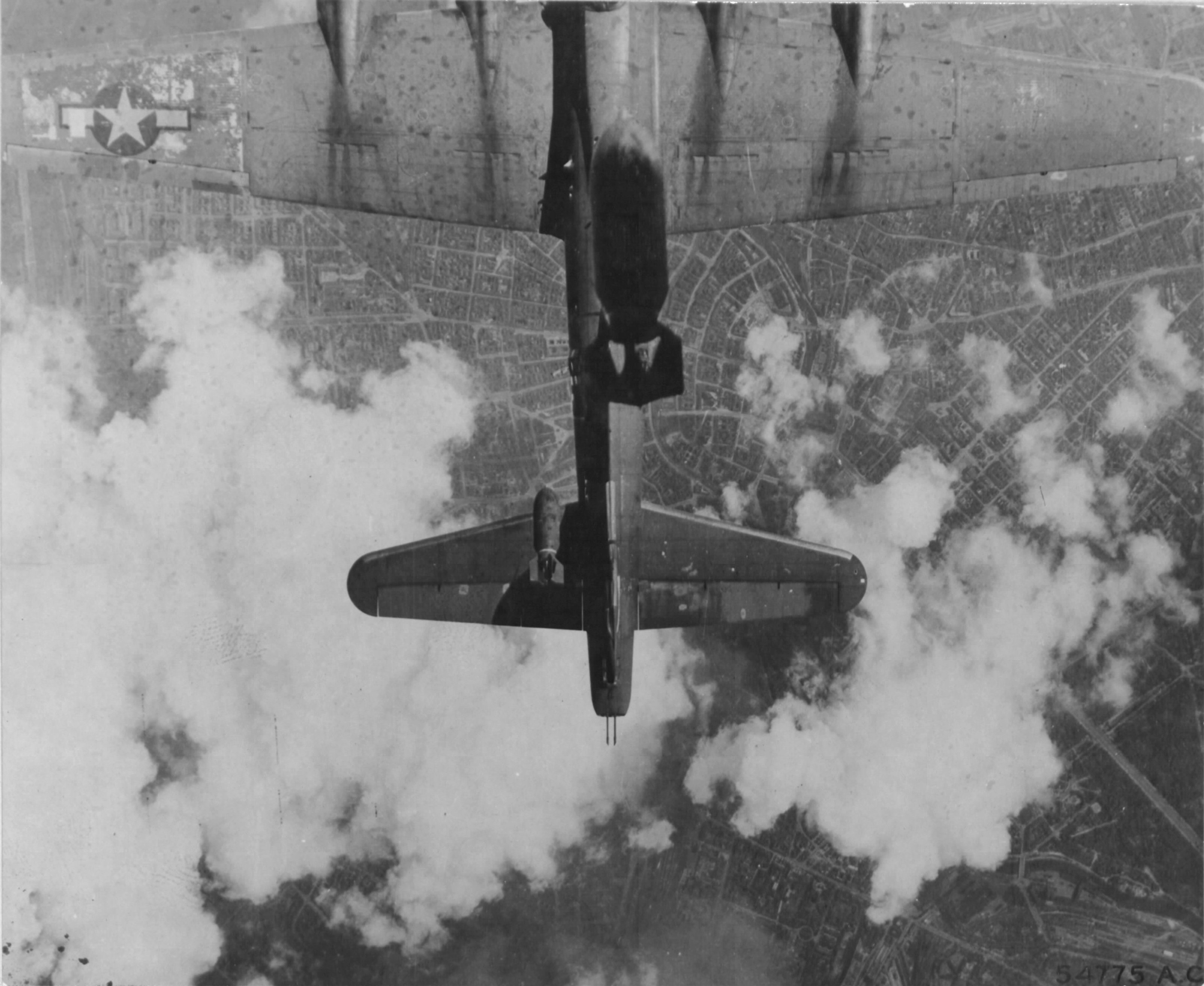 B-17G Fortress 'Miss Donna Mae II' drifted under another bomber on a bomb run over Berlin, 19 May 1944. A 1,000 lb bomb from above tore off the left stabilizer and sent the plane into an uncontrollable spin. All 11 were killed. Photo 1 of 4