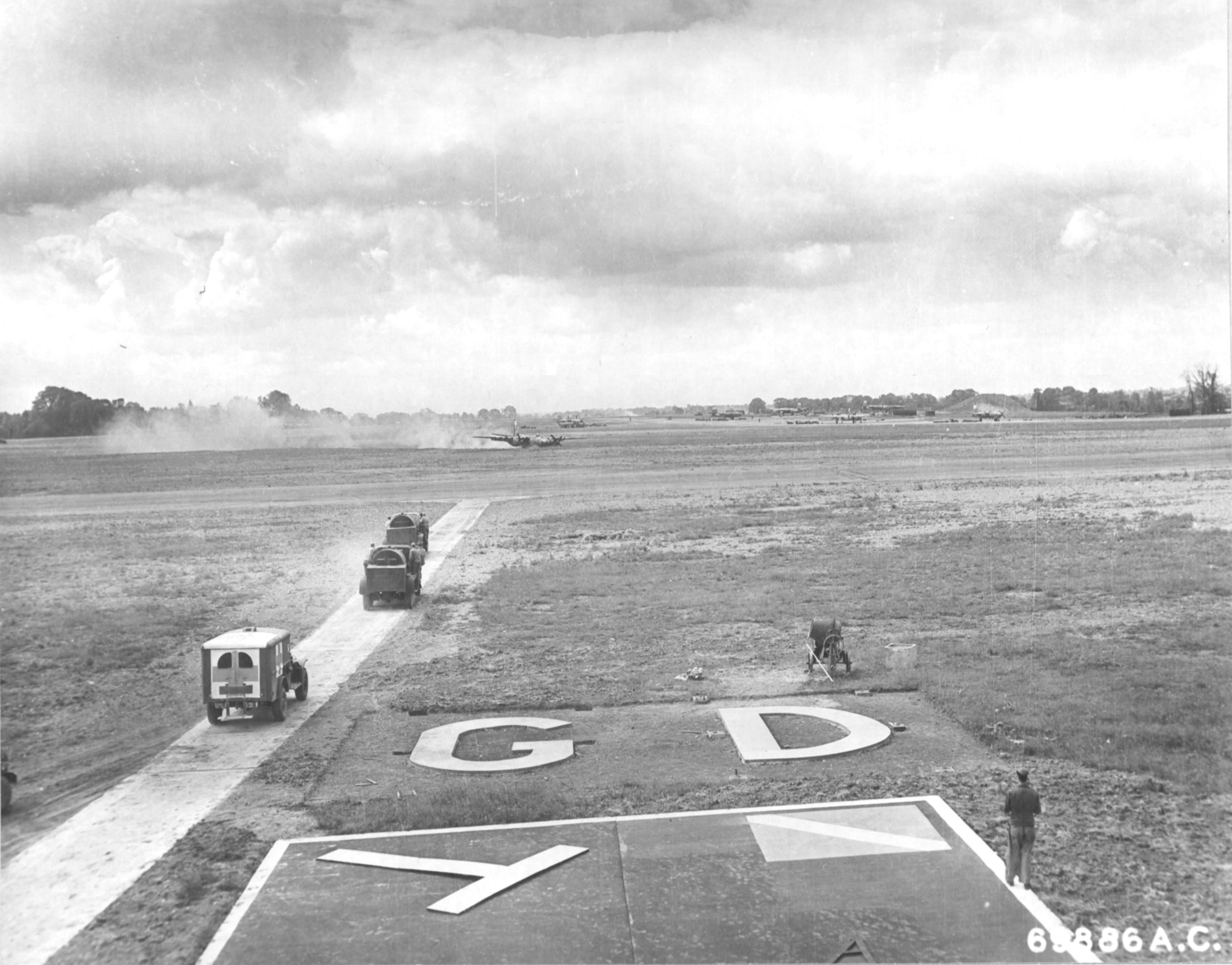 B-26C Marauder “Carefree Carolyn” of the 552nd Bomb Squadron makes a wheels-up landing after having her hydraulics shot out, RAF Great Dunmow, Essex, England, June 15 1944. Note the WC54 Ambulance and fire crews rushing to the scene. Photo 1 of 2