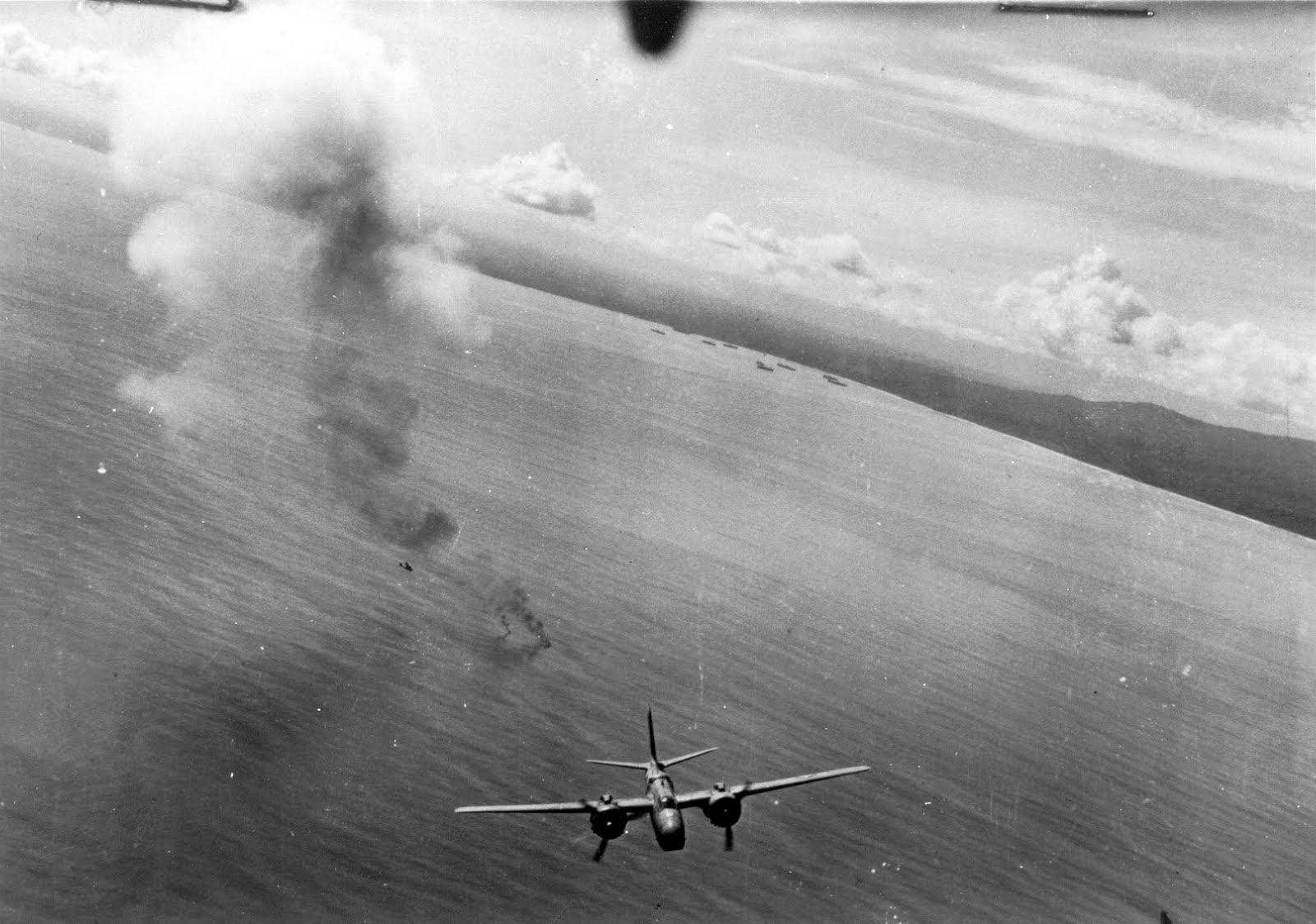 A-20G Havoc of the 312th Bomb Group, the “Roarin’ 20s,” supporting the landings at Cape Sansapor, New Guinea, Jul-Aug 1944. The smoke rising from the water is a downed aircraft with a rescue PBY circling.