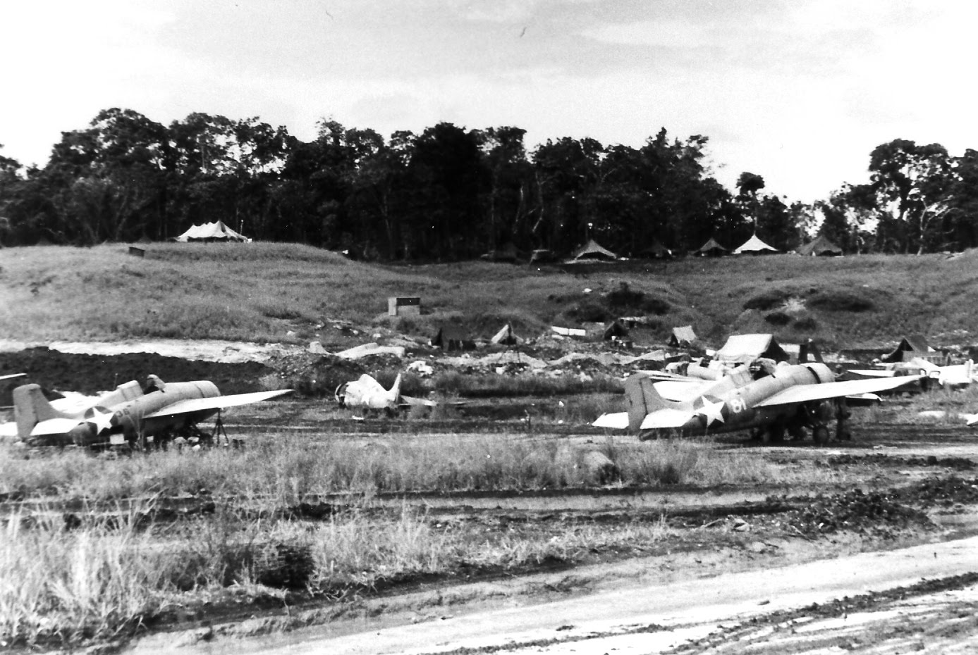 F4F-4 Wildcat fighters of a Marine Fighting Squadron at rest on Henderson Field, Guadalcanal, Solomons, 1942-43.