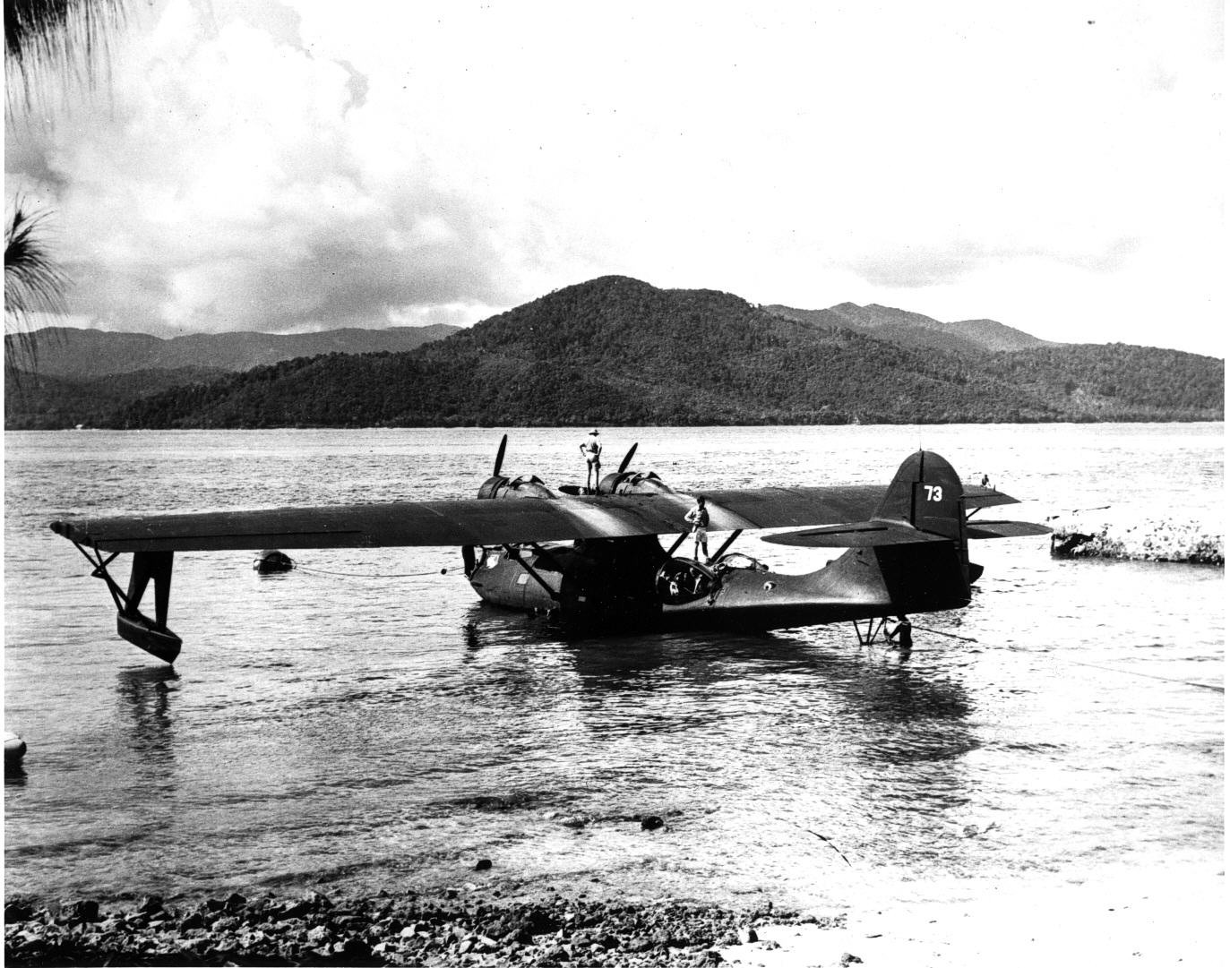 A PBY-5 Catalina of Patrol Squadron 34, one of the “Black Cats” night patrol squadrons, at rest at Samarai Island, New Guinea, Jan-Feb 1944. Note the absence of any markings beyond the squadron patch on the bow and the side number on the tail.