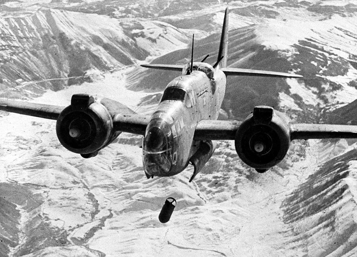 A Model 187 Baltimore light bomber of Royal Air Force 223 Squadron flying from Celone, Italy drops bombs on the railway junction at Sulmona, a strategic point on the east-west route across Italy, in February of 1944