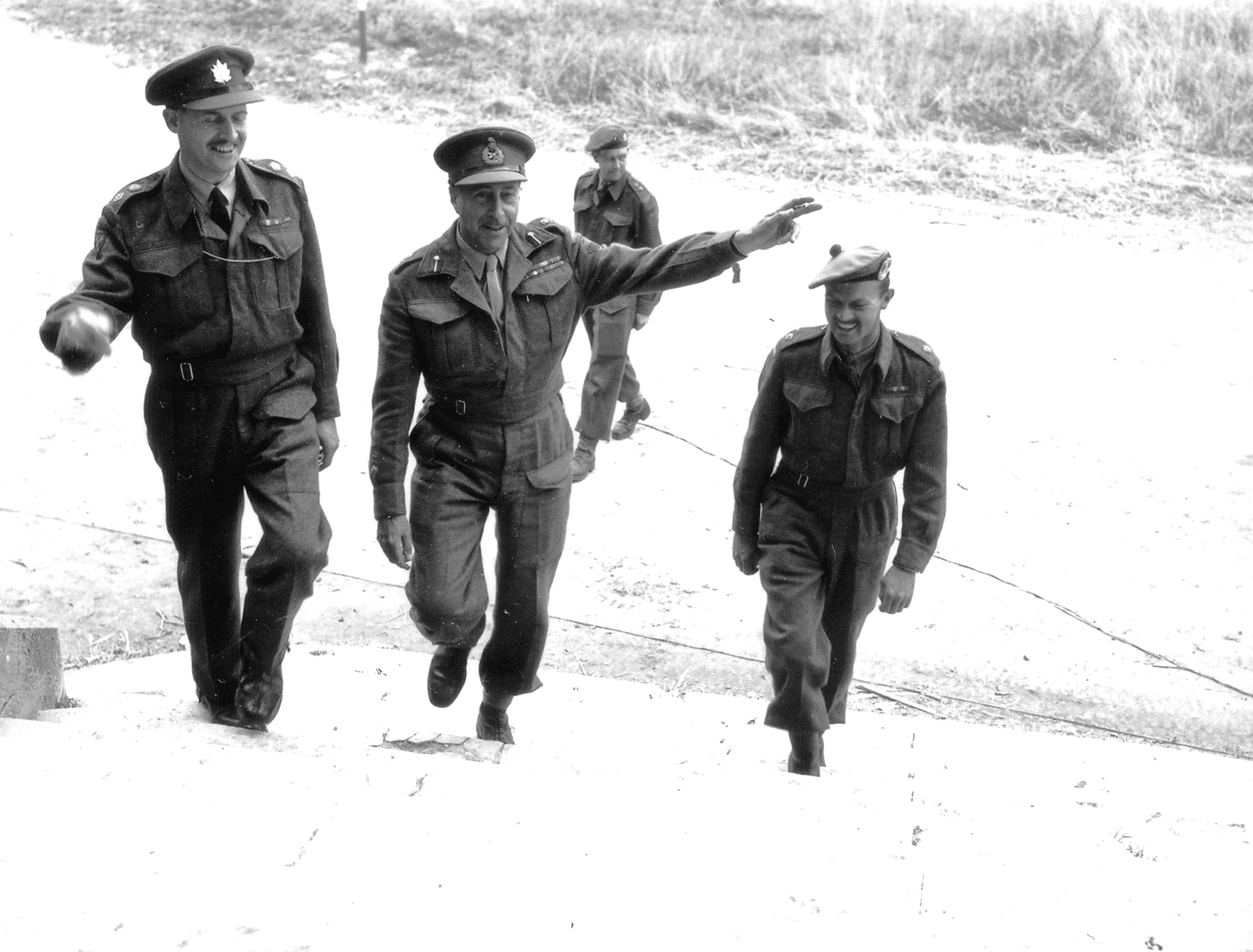 Canadian officers enter Château de Rots, Normandy, France. Left to right they are Colonel Richard S Malone, Lt General Henry Crerar (Commander, 1st Canadian Army) and Major Austin.