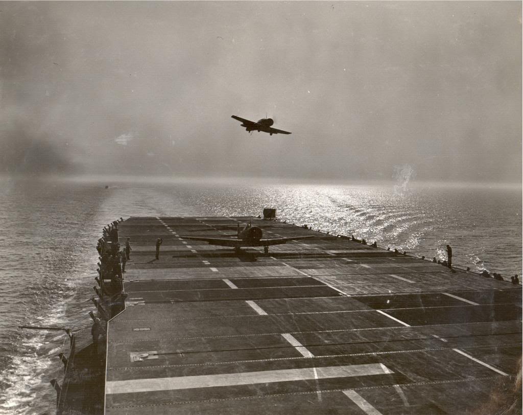 One SNJ Texan has just landed on USS Sable on Lake Michigan, United States as another goes around for another pass, 1943.