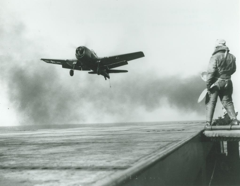 F6F Hellcat lined up for a trap on the training aircraft carrier USS Sable on Lake Michigan, United States, 1945.  Note the LSO’s “paddles” and the extended tailhook on the Hellcat.