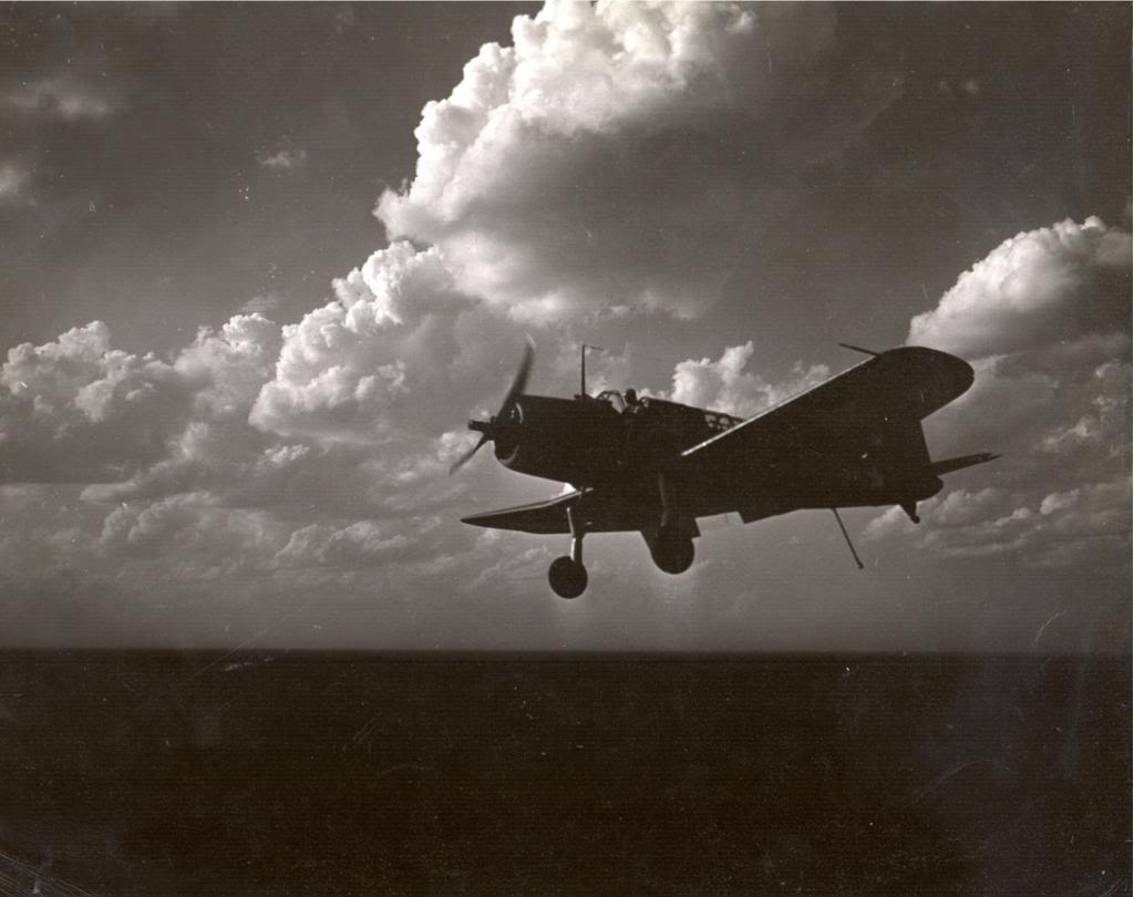On approach to the training aircraft carrier USS Sable on Lake Michigan, United States, an SB2U Vindicator shows the LSO “Gear Down, Flaps Down, Hook Down,” 1943-44.