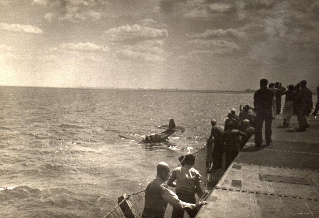 A TBM Avenger after a water landing beside the training aircraft carrier USS Sable on Lake Michigan, United States, 1944-45. Photo 2 of 2.