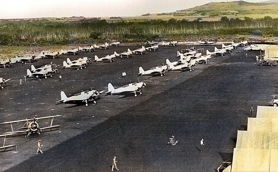 SB2U Vindicators and F3F “Flying Barrels” on the pad viewed from the tower at Marine Corps Air Station Ewa, Oahu, Hawaii, mid-1941. Note the false color added to the photo after the fact.